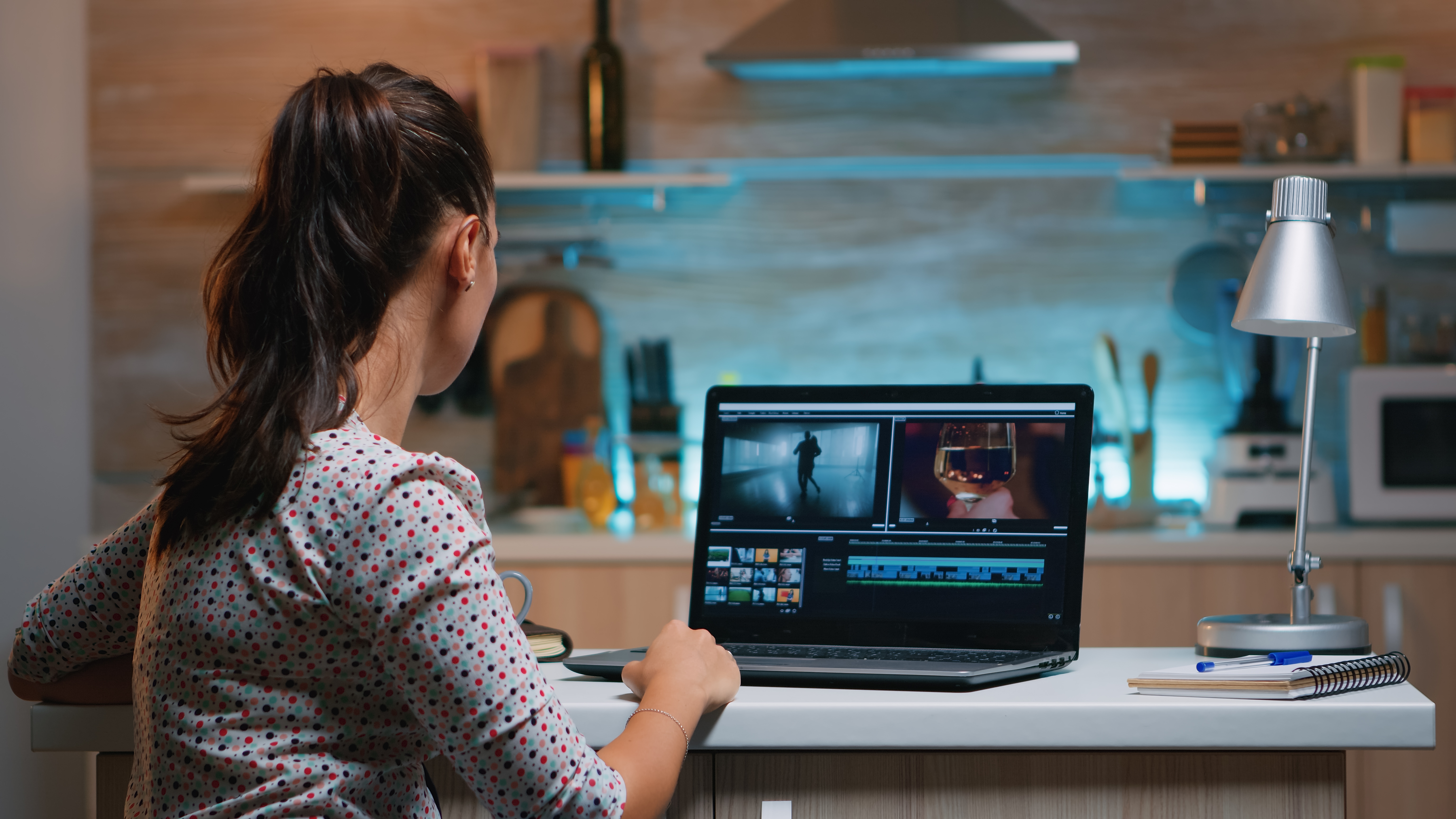 Remote worker editing a video on a laptop.